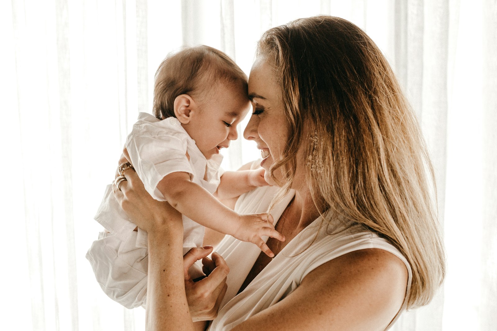 New mother smiling while holding her baby