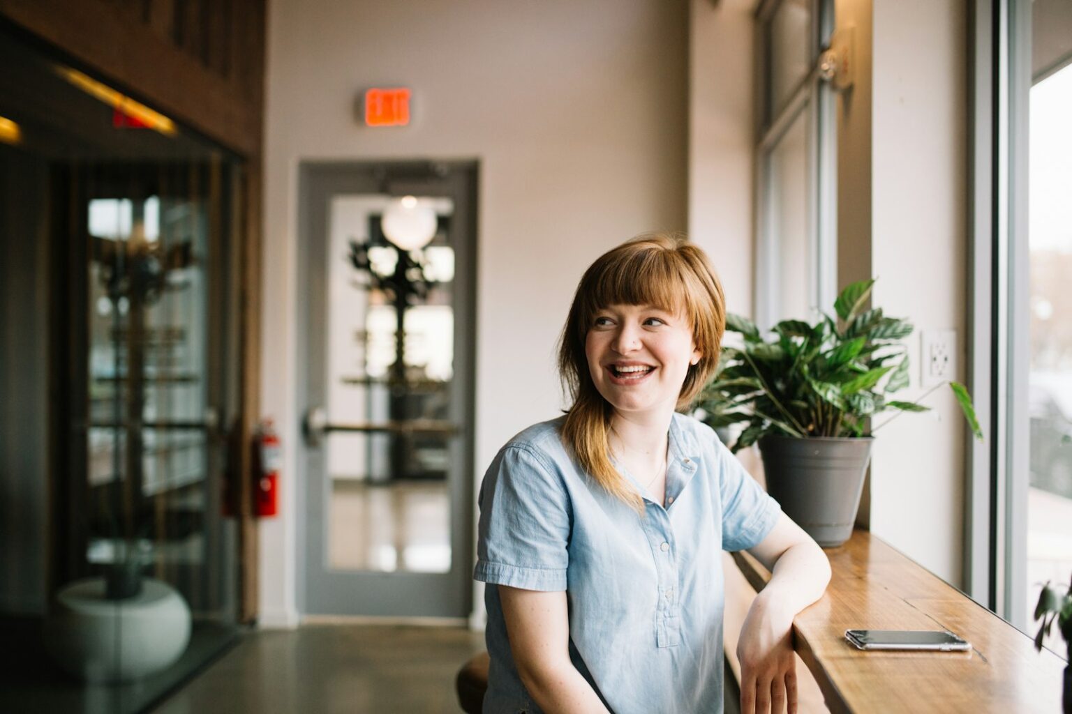 Smiling woman in her 40s at home during perimenopause