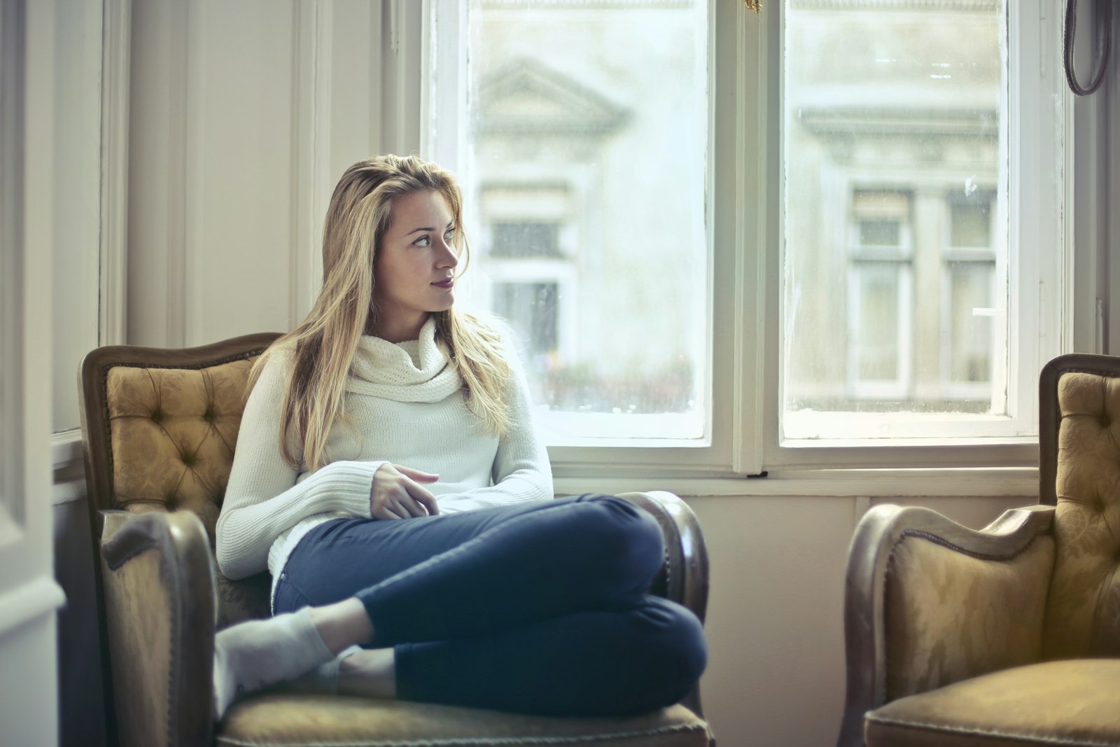 Woman relaxing in an armchair at home