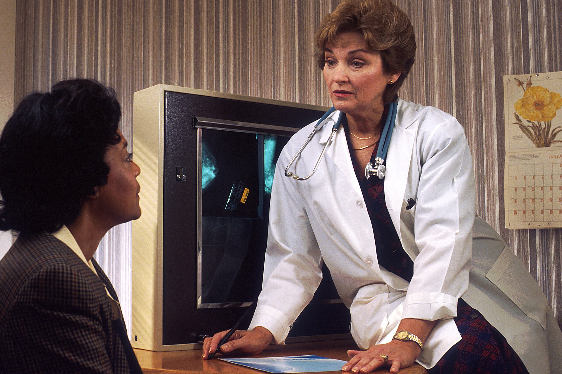 Female doctor talking with a woman patient, illustrating where to find a doctor for vaginal dryness